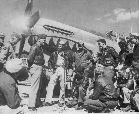 General Chennault converses with his men : pilots of 23d Fighter Group. P-51 Mustang in background. Photograph is part of the public domain.